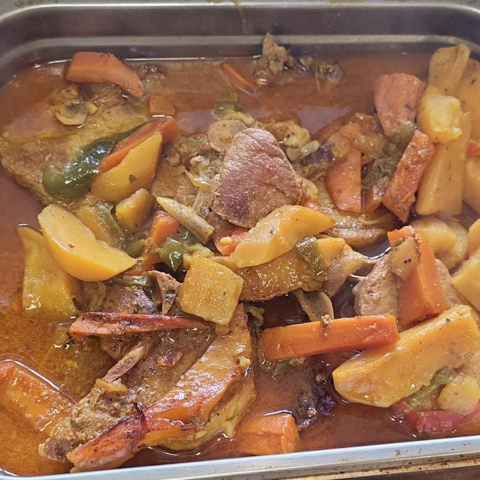 Hearty Latin-American stew with meat, potatoes, carrots, and green peppers in a rich sauce.